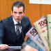 Man in a Suit Speaks into a Microphone at a Podium, with Colorful Banknotes Fanned to the Right, Suggesting Money or Bribery. - Tu Colonia Regia