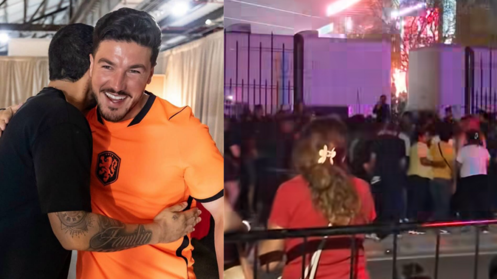 Two Men Hug at an Event; One Wears an Orange Jersey with a Crest and Smiles at the Camera Simple and Friendly Moment in a Backstage Area or Lounge Area. - Tu Colonia Regia