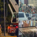 Fan-fest-en-nuevo-leon - Tu Colonia Regia Urban Rescue Collage Showing a Person in a Harness Suspended from a Crane As a Responder Guides the Rope, with a Red Rescue Truck Nearby and Fencing in the Background. - Tu Colonia Regia